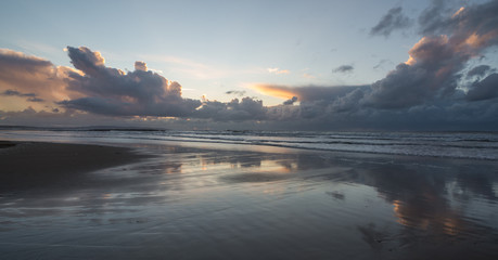 Stormy skies in the distance of west coast beach in Ireland at sunset