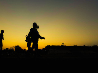 Silhouette teen age run together  track.