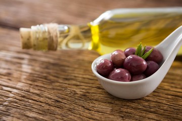 Close-up of marinated oil and olive oil bottle 