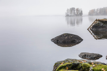 Late fall in Finland. Dark cold foggy morning in the lake