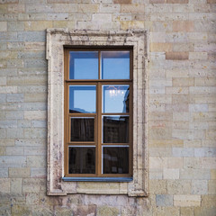 Fototapeta na wymiar Background of city buildings from limestone. Nice window.