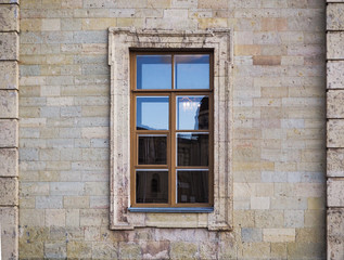 Fototapeta na wymiar Background of city buildings from limestone. Nice window.