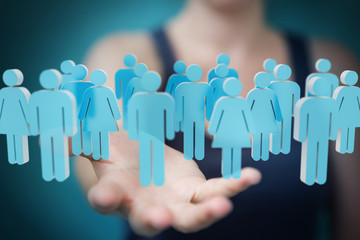 Businesswoman holding and touching 3D rendering group of blue people
