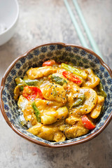 Katsu green chicken curry. Cooked jasmine rice with cooked marinated chicken in coconut, soy sauce, served with vegetables. 