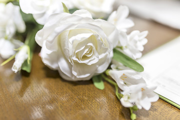 White roses wedding bouquet of flowers shot close up with a shallow depth of field at a tradtional English Wedding