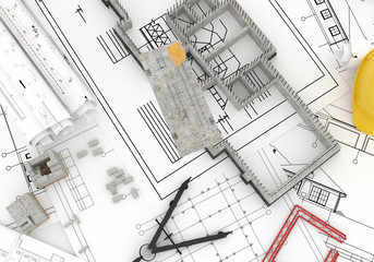 foundation under construction with crane, on top of blueprints