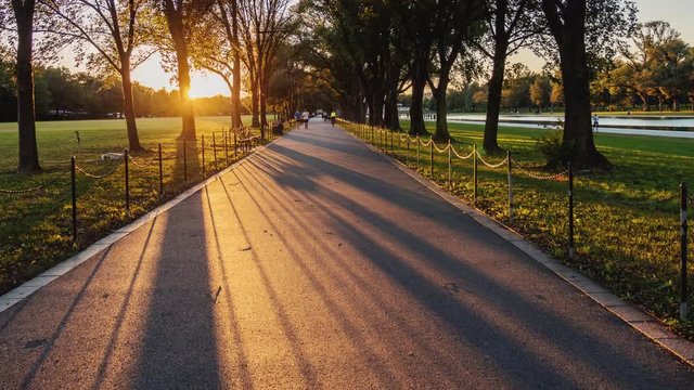 Hyperlapse video: A long avenue for pedestrians at sunset. People go jogging. Washington, DC