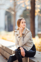 Fototapeta premium Pretty woman sit on the bench and smile