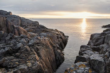 Fototapeta na wymiar Sunrise on the Baltic sea with sunlit rocks.