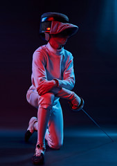 male fencer standing on black background