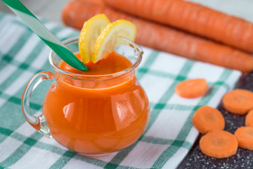 Carrot juice in glass and fresh carrots. Healthy food.