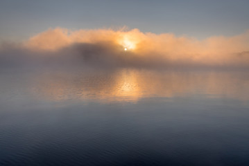 Fog over Mary Lake at sunrise in Port Sydney, Ontario, Canada.