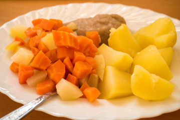 Dinner meal, braised carrot, boiled potatoes and meat