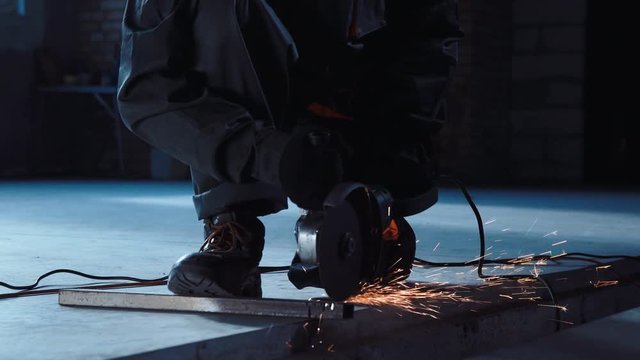 Construction worker preparing to cut with angle grinder