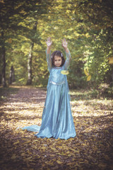 Little and happy girl playing in the woods,selective focus