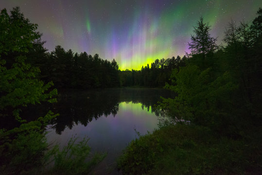 Northern Lights over a small pond, Muskoka, Ontario, Canada.