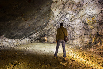 Miner in the underground quartz ore mine shaft tunnel