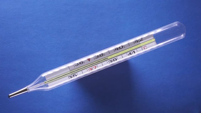 Temperature on the mercury medical thermometer grows up to 38 degrees