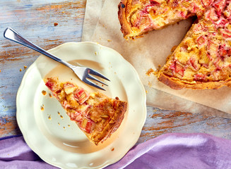 Homemade pie with rhubarb and custard on wooden table © robertsre