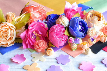 Flowers of FoamIran. Hand Made flowers. The material of the workpiece. On wooden background.