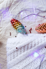 Christmas toys with a garland on a knitted sweater