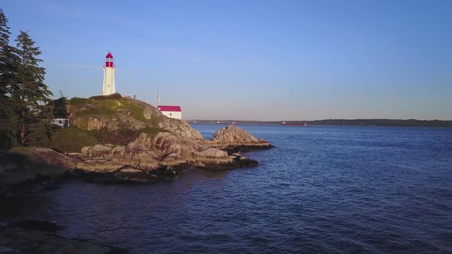 Aerial 4k drone footage of a popular landmark, Lighthouse Park, during a vibrant summer sunset. Taken in Horseshoe Bay, West Vancouver, British Columbia, Canada.