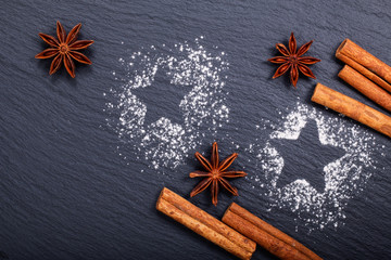Background Christmas and New year Concept cinnamon and star anise on black slate stone background