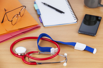 Stethoscope and a smart phone on a doctors desk