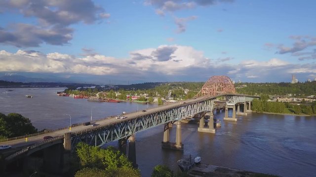 Aerial 4k footage of Pattullo Bridge going across Fraser River between Surrey and New Westminster. Taken in Greater Vancouver, British Columbia, Canada.