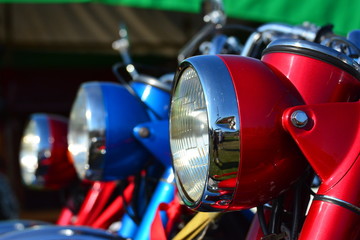 Vintage motorcycle headlights, red, blue