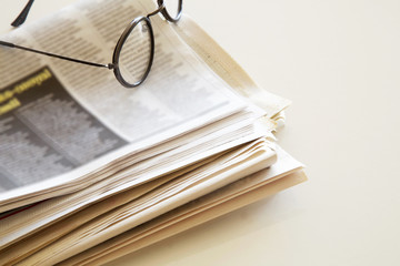 Newspaper with coffee on brown background