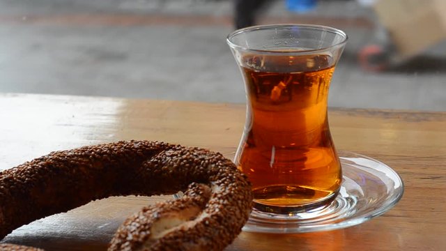 Turkish tea and simit on wooden table.