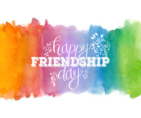 Happy Friendship day, holiday of best friends. Hand drawn congratulatory inscription on multicolored abstract watercolor background. Creative lettering design for greeting card, poster or art design.