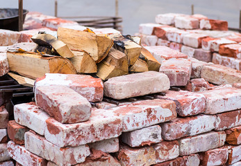 Red brick with limestone outdoor fireplace with chopped birch firewood on a brazier
