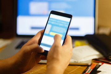 Male hand holding a mobile phone. Online payments and purchases. The banking application is opened on a smartphone.