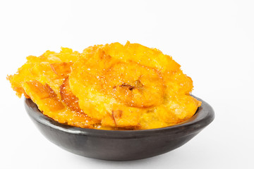 Plantain patacones on black ceramic dish