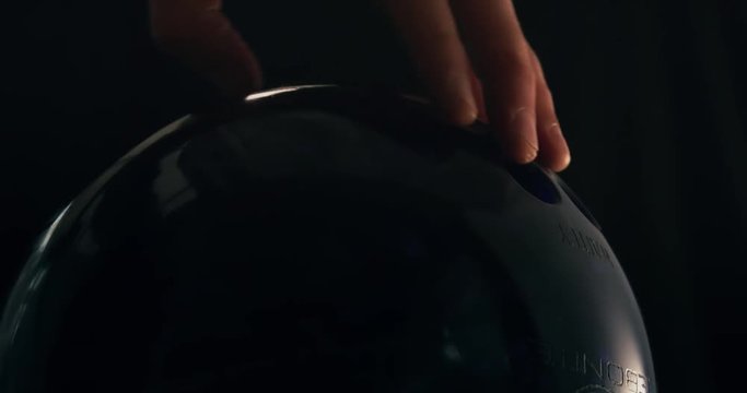 Male hand picking up a tenpin bowling ball to aim and strike