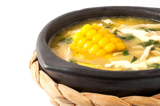 Traditional Colombian ajiaco served on black ceramic dish