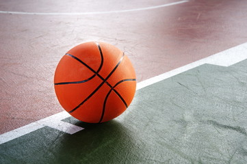 orange basketball on green brown court of gymnasium sport floor background