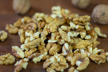 Peeled walnuts on a wooden background