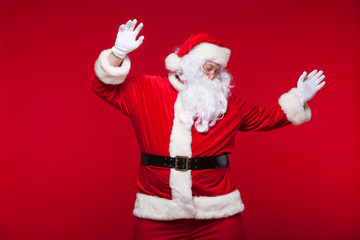 Santa Claus is dancing Isolated on red background.