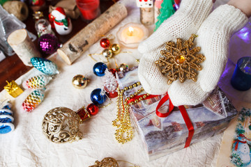 A composition of Christmas toys and hands with mittens