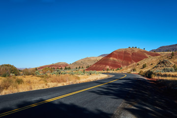John Day Painted Hills in Oregon with Road and Blue Sky