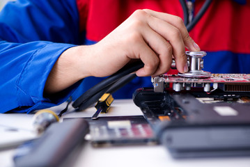 Repairman working in technical support fixing computer laptop tr