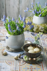 Bouquet of muscari flowers (grape hyacinth) and bowl with water and floating candles