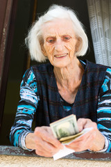 Grandma counting retirement money at home