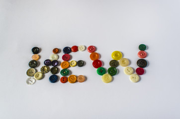 Many different buttons. Buttons for clothes made of plastic. View from above.