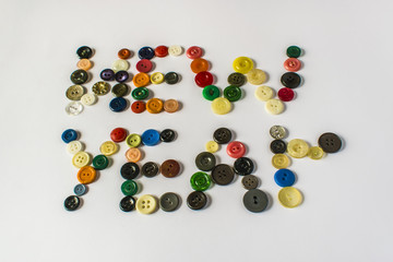 Many different buttons. Buttons for clothes made of plastic. View from above.