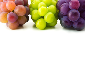 red, black and white (green) grapes on pure white surface.