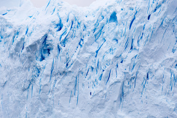 A huge iceberg has calved from a glacier. Showing beautiful blue ice